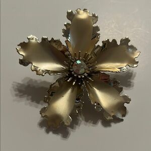 Elegant Gold Flower Brooch. Brushed gold toned. Rhinestone center.
